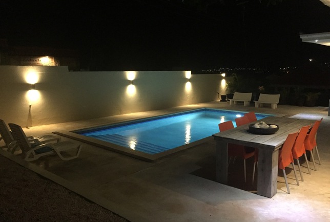 Preview a overview pool dinertable beach chairs night villa breeze curacao